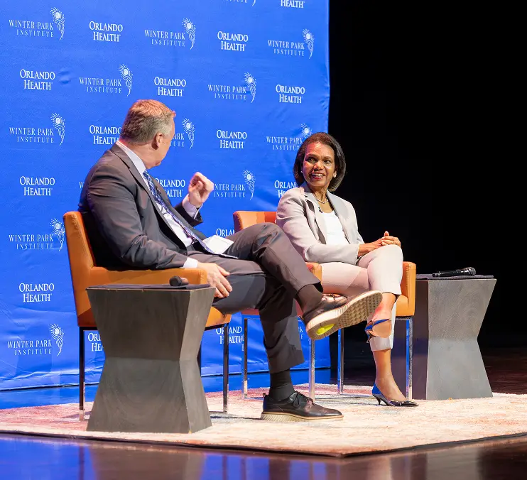 Condoleezza Rice in conversation with an interviewer onstage at a Winter Park Institute event.